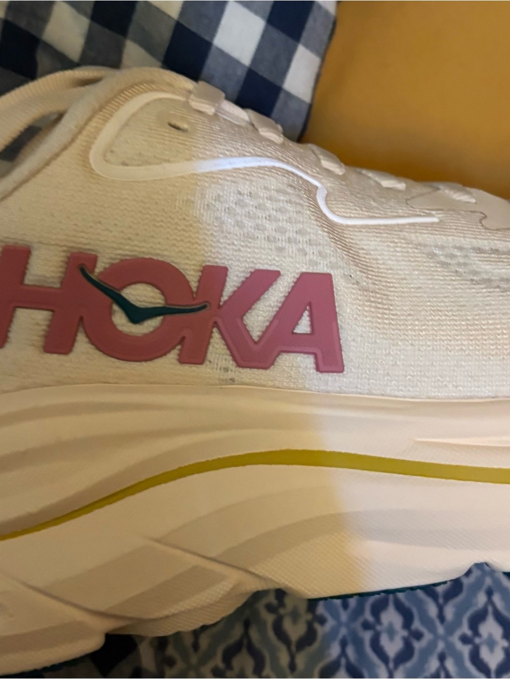 Hoka women’s Clifton 10 cream with pink and Teal Logo